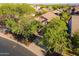 Aerial view of a house nestled among trees, with a view of the neighborhood at 3055 N Red Mtn # 122, Mesa, AZ 85207