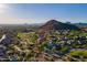 Expansive aerial view of a lush community surrounded by desert landscape and mountains at 3055 N Red Mtn # 122, Mesa, AZ 85207