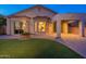 Charming home featuring a manicured lawn, covered patio and well-lit windows at 3055 N Red Mtn # 122, Mesa, AZ 85207