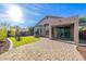 Expansive backyard with artificial turf, brick pavers and covered patio space at 3055 N Red Mtn # 122, Mesa, AZ 85207