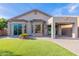 Backyard featuring artificial turf, desert landscaping, and covered patio at 3055 N Red Mtn # 122, Mesa, AZ 85207