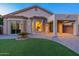 Desert home backyard featuring lush artificial grass, covered patio, and desert landscaping at 3055 N Red Mtn # 122, Mesa, AZ 85207