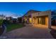 Cozy desert home backyard featuring lush artificial grass, covered patio and a desert garden at 3055 N Red Mtn # 122, Mesa, AZ 85207