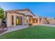 Beautiful backyard with artificial turf, a covered patio, and desert landscaping at 3055 N Red Mtn # 122, Mesa, AZ 85207