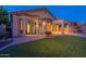 Home featuring a lush green lawn, covered patio and backyard landscaping at 3055 N Red Mtn # 122, Mesa, AZ 85207