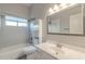 Clean bathroom featuring a shower-tub combo and a large mirror above the sink at 3055 N Red Mtn # 122, Mesa, AZ 85207