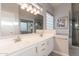 Well-lit bathroom with double sinks, a large mirror, and glass-enclosed shower at 3055 N Red Mtn # 122, Mesa, AZ 85207