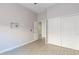Bright bedroom featuring wood-look tile flooring, closet and modern gray walls at 3055 N Red Mtn # 122, Mesa, AZ 85207