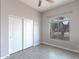 Bedroom with wood-look floors, sliding closet doors, and a sunny window at 3055 N Red Mtn # 122, Mesa, AZ 85207
