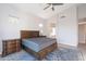 Bright bedroom with a ceiling fan, a decorative rug, and access to the bathroom at 3055 N Red Mtn # 122, Mesa, AZ 85207