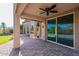The covered patio features brick pavers and views of the landscaped backyard at 3055 N Red Mtn # 122, Mesa, AZ 85207