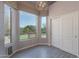 Charming dining area featuring large windows, stylish lighting, and elegant gray wood-look floors at 3055 N Red Mtn # 122, Mesa, AZ 85207