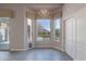 Bright dining area with large windows offering backyard views, modern lighting, and wood-look tile flooring at 3055 N Red Mtn # 122, Mesa, AZ 85207