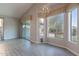 Open dining space featuring sliding glass door, bright windows, modern lighting, and stylish gray wood-look flooring at 3055 N Red Mtn # 122, Mesa, AZ 85207