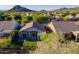 Aerial view of a single-story home with a well-manicured lawn and desert landscaping in a mountain community at 3055 N Red Mtn # 122, Mesa, AZ 85207