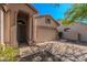 Single-story home with tan stucco and desert landscaping, and a two car garage at 3055 N Red Mtn # 122, Mesa, AZ 85207