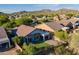 Aerial view of a single-story home with a well-manicured lawn and desert landscaping in a mountain community at 3055 N Red Mtn # 122, Mesa, AZ 85207