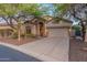 Charming home exterior featuring desert landscaping, two-car garage and private entrance at 3055 N Red Mtn # 122, Mesa, AZ 85207