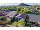 Aerial view of a single-story home with a well-manicured lawn and desert landscaping in a mountain community at 3055 N Red Mtn # 122, Mesa, AZ 85207