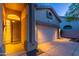 Well-lit two car garage and front door with sidelights on a single story home at 3055 N Red Mtn # 122, Mesa, AZ 85207