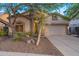 Charming single-story home with a two-car garage, desert landscaping, and mature trees at 3055 N Red Mtn # 122, Mesa, AZ 85207