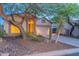 Quaint single-story home with desert landscaping and two-car garage at twilight at 3055 N Red Mtn # 122, Mesa, AZ 85207