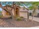 Front view of a single-story house with desert landscaping and a two-car garage at 3055 N Red Mtn # 122, Mesa, AZ 85207