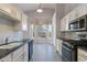 Well-designed kitchen with white cabinetry, stainless steel appliances, and an adjacent bright dining space at 3055 N Red Mtn # 122, Mesa, AZ 85207