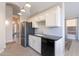 Bright kitchen featuring stainless steel appliances, white cabinets, and black countertops at 3055 N Red Mtn # 122, Mesa, AZ 85207