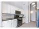 Modern kitchen featuring white cabinets, stainless steel appliances, and elegant black granite countertops at 3055 N Red Mtn # 122, Mesa, AZ 85207
