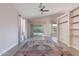 Living room with vaulted ceilings, ceiling fan and ceramic tile floors and built-in shelving at 3055 N Red Mtn # 122, Mesa, AZ 85207
