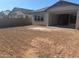 A spacious backyard awaits landscaping, connecting to a covered patio through sliding glass doors at 3637 E Rochelle Cir, Mesa, AZ 85213