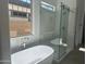 Spa-like bathroom featuring a freestanding tub, glass shower, and modern fixtures at 3637 E Rochelle Cir, Mesa, AZ 85213
