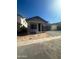 Charming single-story home featuring a brick-accented facade and a two-car garage on a sunny day at 3637 E Rochelle Cir, Mesa, AZ 85213