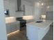 Modern kitchen boasts white cabinets, stainless steel appliances, and a large island with a sink at 3637 E Rochelle Cir, Mesa, AZ 85213