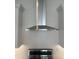 Close-up of a stainless steel range hood and white subway tile backsplash in a modern kitchen setting at 3637 E Rochelle Cir, Mesa, AZ 85213