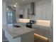 Modern kitchen with white cabinetry, a central island, stainless steel appliances, and pendant lighting at 3637 E Rochelle Cir, Mesa, AZ 85213