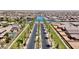 Stunning aerial view of a Primary-planned community featuring palm-lined streets and waterfront homes with lake access at 41143 W Rio Bravo Dr, Maricopa, AZ 85138