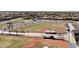 Aerial shot of a well-maintained baseball field within a residential community, ready for a game at 41143 W Rio Bravo Dr, Maricopa, AZ 85138