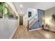 Inviting entryway featuring wood-look floors, modern decor, and stylish staircase, offering a warm welcome to the home at 41143 W Rio Bravo Dr, Maricopa, AZ 85138