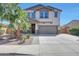 Attractive two-story home with a well-manicured front yard and a spacious two-car garage at 41143 W Rio Bravo Dr, Maricopa, AZ 85138