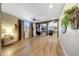 Well-lit open concept living space, with hardwood floors, an aquarium, and views to other rooms at 41143 W Rio Bravo Dr, Maricopa, AZ 85138