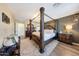 Luxurious main bedroom with hardwood floors, canopy bed, and stylish decor, creating a comfortable and elegant retreat at 41143 W Rio Bravo Dr, Maricopa, AZ 85138