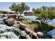 Charming waterfall feature enhancing the serene lake view in this community at 41143 W Rio Bravo Dr, Maricopa, AZ 85138