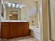 Primary bathroom featuring dual sinks, a soaking tub, and separate glass enclosed shower at 4117 W Allen St, Laveen, AZ 85339