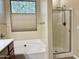 Bright bathroom featuring a tub, separate shower, and window with natural light at 4117 W Allen St, Laveen, AZ 85339