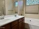 Well-lit bathroom featuring dual sinks and a separate soaking tub, ideal for relaxation at 4117 W Allen St, Laveen, AZ 85339