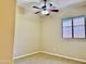Neutral bedroom with a ceiling fan and window view at 4117 W Allen St, Laveen, AZ 85339