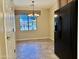 Cozy dining area with a chandelier and large window for ample natural light next to the kitchen at 4117 W Allen St, Laveen, AZ 85339