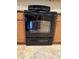 The oven is black with a glass door panel, matching the other kitchen appliances at 4117 W Allen St, Laveen, AZ 85339